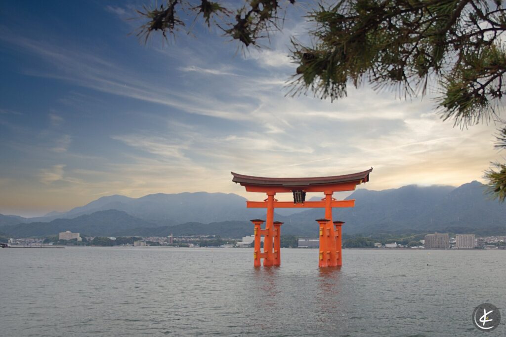 Blick durch einen Baum auf den Itsukushima-Schreins bei Flut